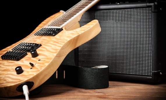 Electric guitar and amplifier on dark background