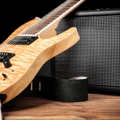 Electric guitar and amplifier on dark background