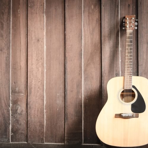 Wood guitar against wall